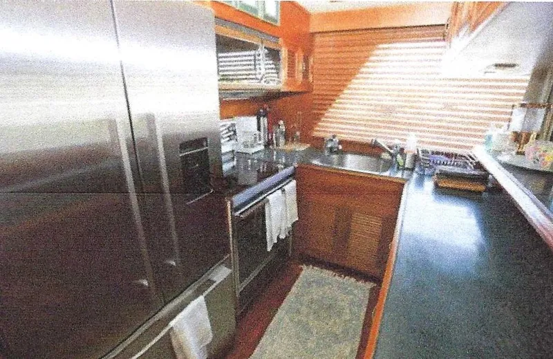 Slide: The Image of 1984 Ocean Alexander Flying Bridge Motor Yacht kitchen with stainless steel appliances and wooden cabinetry. - 24