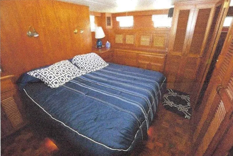 Slide: The Image of Luxurious bedroom in 1984 Ocean Alexander Flying Bridge Motor Yacht with wooden interior. - 28