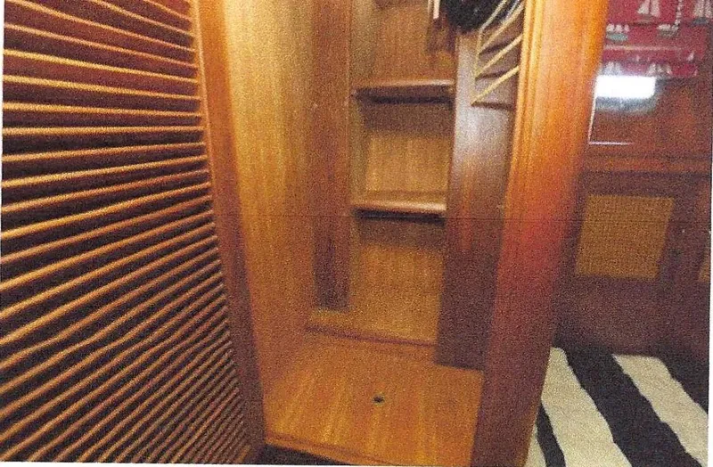 Slide: The Image of 1984 Ocean Alexander Flying Bridge Motor Yacht interior with wooden shelves and striped flooring. - 34