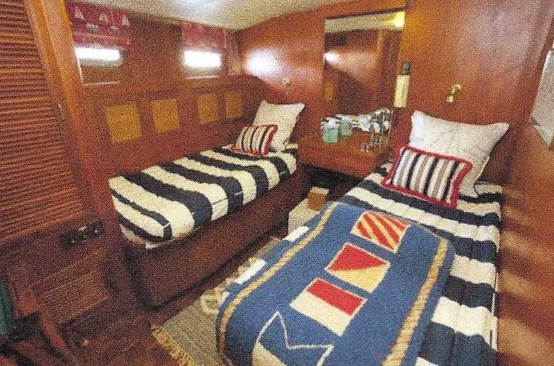 Slide: The Image of 1984 Ocean Alexander Flying Bridge Motor Yacht cabin with twin beds and nautical-themed decor. - 36