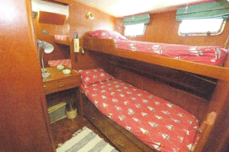 Slide: The Image of 1984 Ocean Alexander Flying Bridge Motor Yacht cabin with bunk beds and nautical-themed decor. - 38