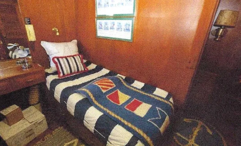 Slide: The Image of 1984 Ocean Alexander Flying Bridge Motor Yacht cabin with nautical-themed bedding and wooden interior. - 39
