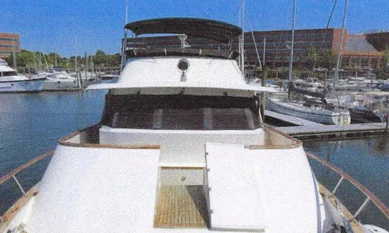 Slide: The Image of 1984 Ocean Alexander Flying Bridge Motor Yacht docked in marina, sunny day, clear blue sky. - 4