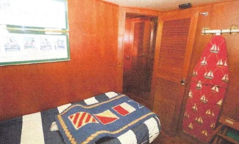 Slide: The Image of 1984 Ocean Alexander Flying Bridge Motor Yacht cabin with nautical-themed decor and wooden interior. - 41