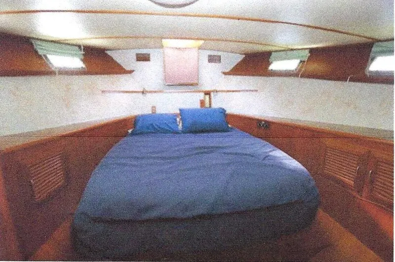 Slide: The Image of 1984 Ocean Alexander Flying Bridge Motor Yacht cabin with bed and wooden interior. - 44