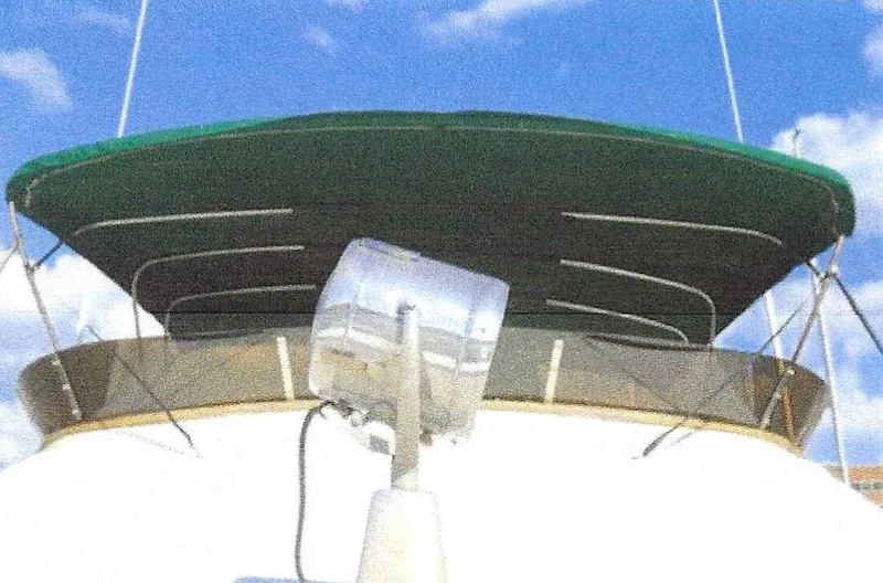 Slide: The Image of 1984 Ocean Alexander Flying Bridge Motor Yacht with green canopy against blue sky. - 46
