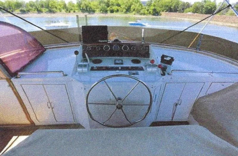 Slide: The Image of 1984 Ocean Alexander Flying Bridge Motor Yacht helm with steering wheel and control panel. - 47