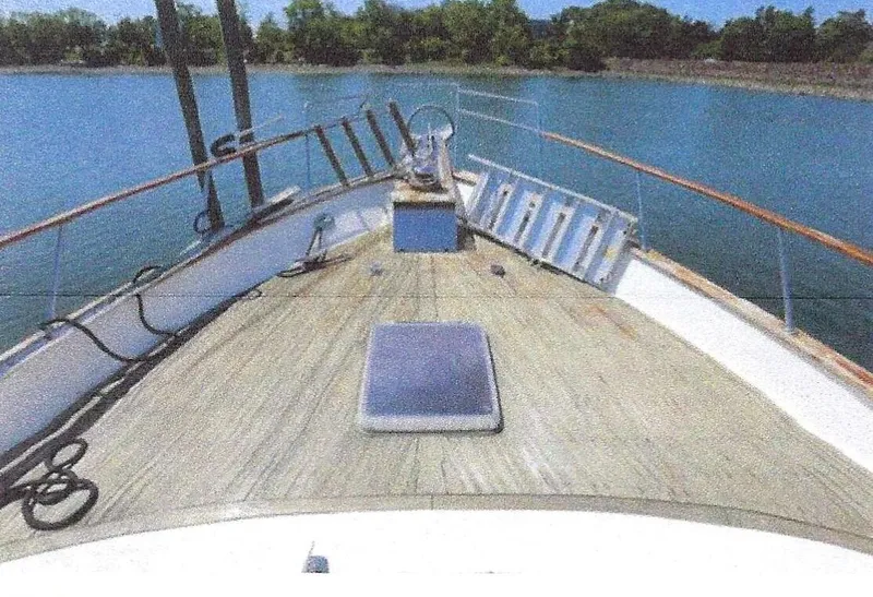 Slide: The Image of 1984 Ocean Alexander Flying Bridge Motor Yacht on calm water, view from the deck. - 6