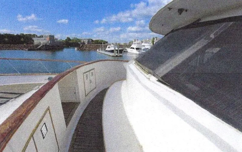 Slide: The Image of 1984 Ocean Alexander Flying Bridge Motor Yacht docked in a marina under a clear blue sky. - 7