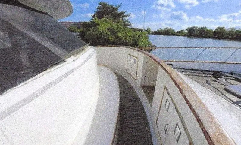 Slide: The Image of 1984 Ocean Alexander Flying Bridge Motor Yacht on a serene river with lush greenery. - 8