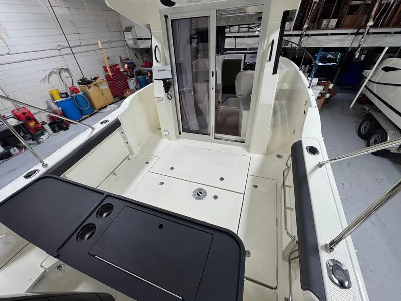 Slide: The Image of 2025 Trophy 25 Pilothouse boat interior, featuring spacious deck and seating area. - 2