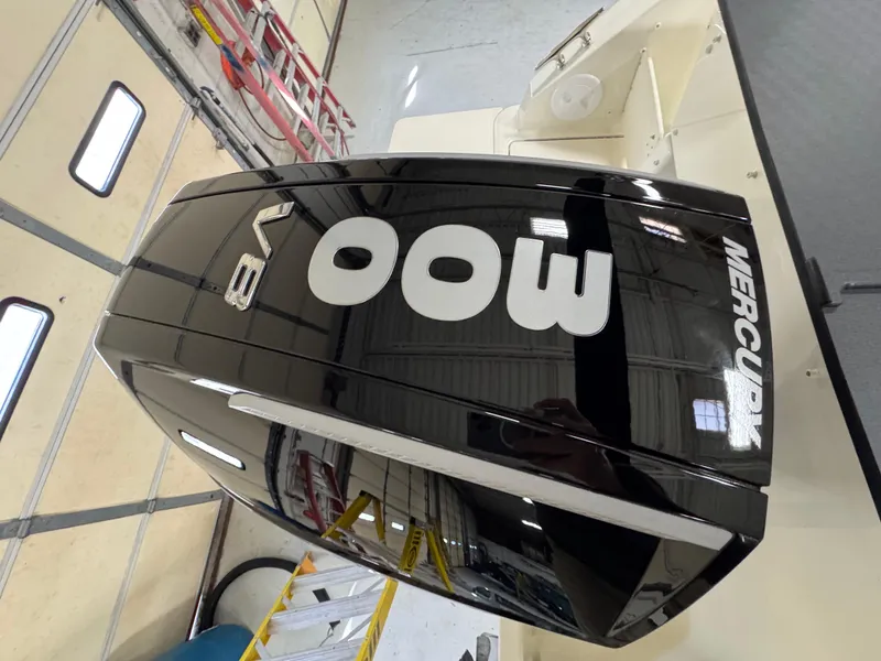 Slide: The Image of 2025 Trophy 25 Pilothouse with powerful Mercury V8 400 outboard engine in a garage setting. - 3