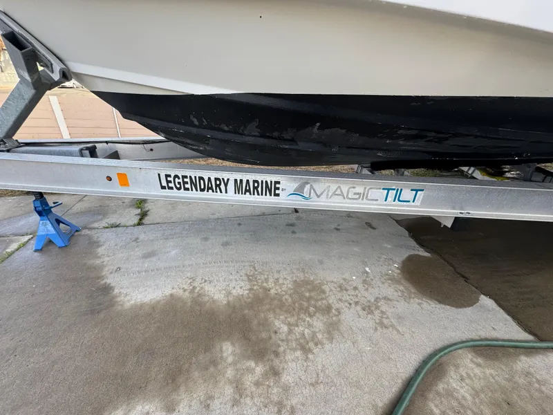 Slide: The Image of 2006 Boston Whaler 235 Conquest on Magic Tilt trailer, parked on concrete. - 13