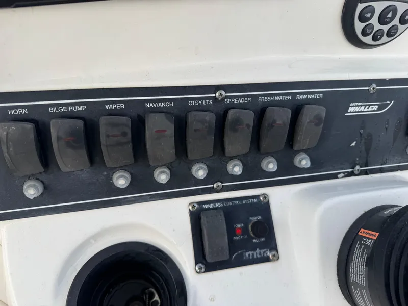 Slide: The Image of Control panel of a 2006 Boston Whaler 235 Conquest boat with labeled switches. - 17