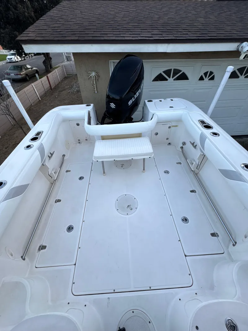 Slide: The Image of 2006 Boston Whaler 235 Conquest boat deck with Suzuki outboard motor, spacious and well-equipped. - 18