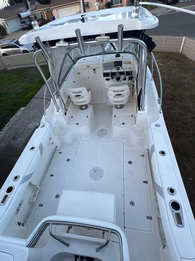 Slide: The Image of 2006 Boston Whaler 235 Conquest boat interior, featuring dual seats and spacious deck. - 19