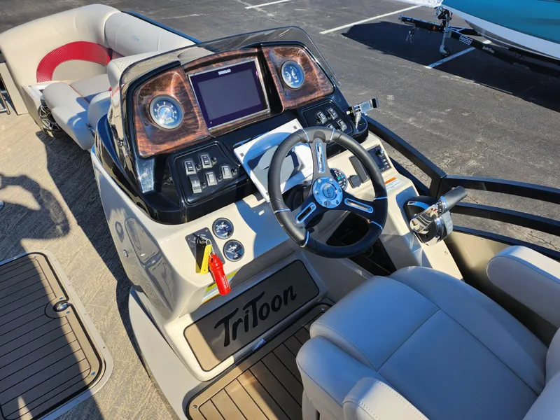 Slide: The Image of 2022 JC Neptoon 25 TT DSL boat dashboard with steering wheel and control panel. - 19