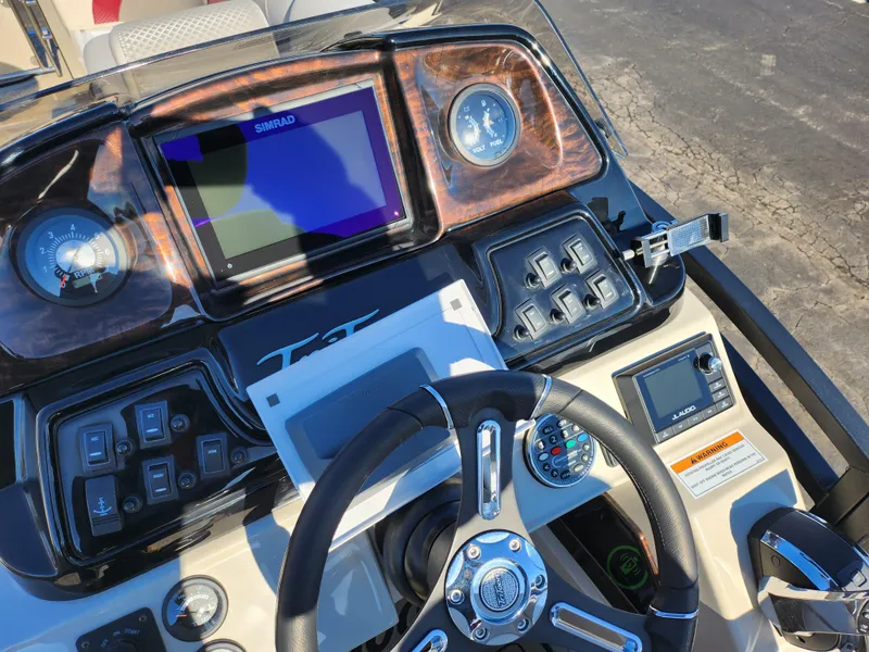 Slide: The Image of Dashboard of 2022 JC Neptoon 25 TT DSL boat with steering wheel and controls. - 21