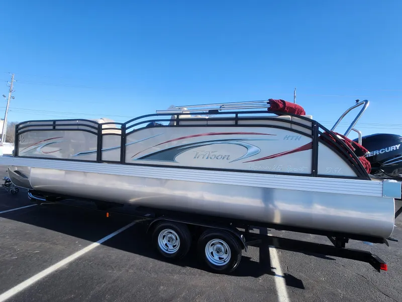 Slide: The Image of 2022 JC Neptoon 25 TT DSL pontoon boat on trailer, parked outdoors. - 4
