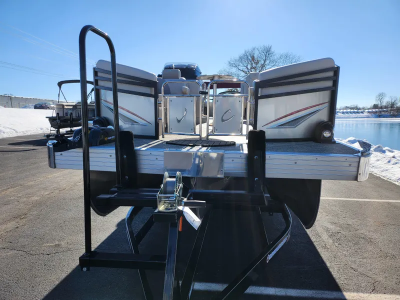 Slide: The Image of 2022 JC Neptoon 25 TT DSL pontoon boat on trailer, parked near a lake. - 6