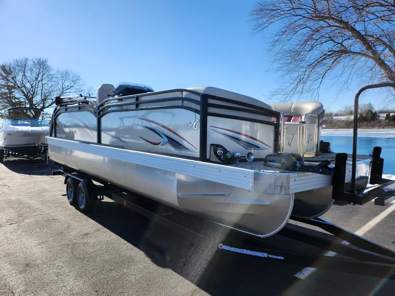 Slide: The Image of 2022 JC Neptoon 25 TT DSL pontoon boat on trailer, parked near a lake. - 8