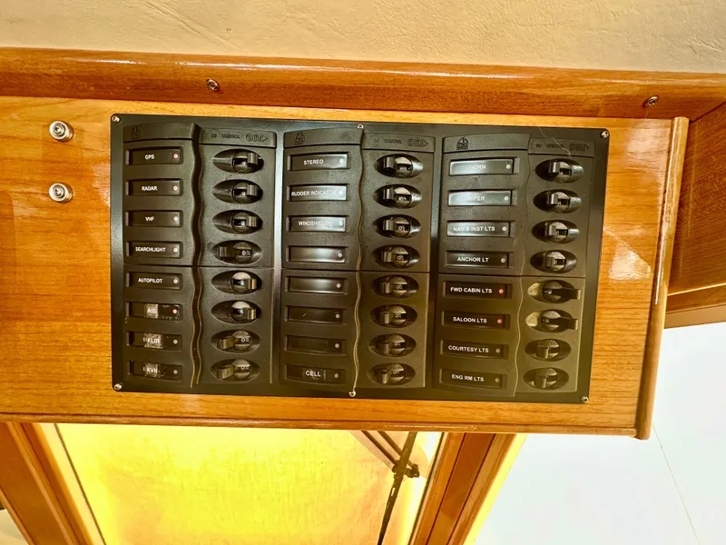 Slide: The Image of Control panel on 2001 Grand Banks 49 Eastbay HX yacht, featuring multiple switches. - 14