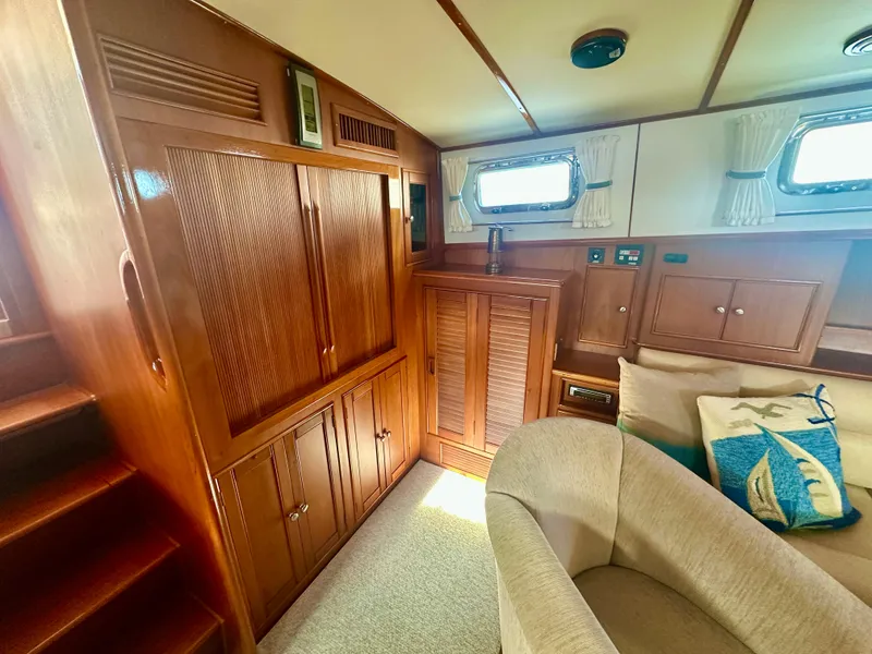 Slide: The Image of Interior of 2001 Grand Banks 49 Eastbay HX with wooden cabinetry and cozy seating. - 23