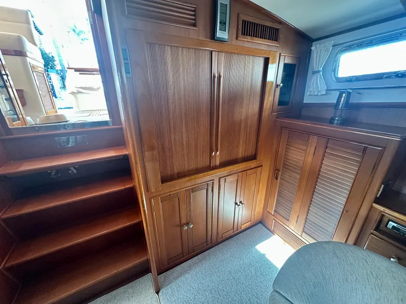 Slide: The Image of Interior of 2001 Grand Banks 49 Eastbay HX with wooden cabinetry and stairs. - 24