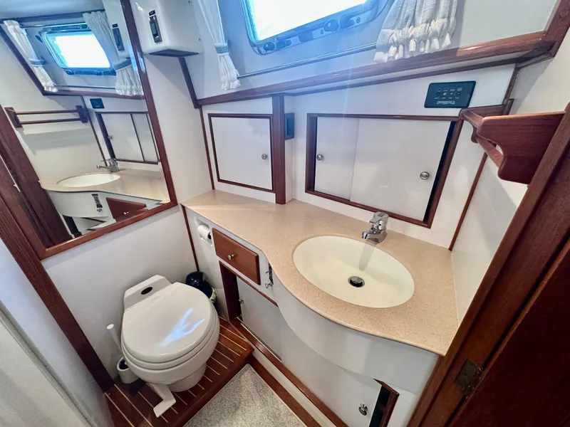 Slide: The Image of Bathroom interior of 2001 Grand Banks 49 Eastbay HX yacht, featuring sink and toilet. - 32
