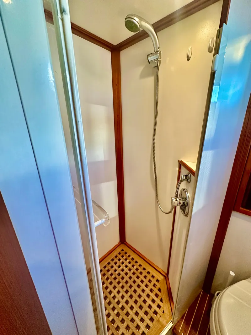Slide: The Image of Shower area in 2001 Grand Banks 49 Eastbay HX yacht, featuring wood accents and modern fixtures. - 33
