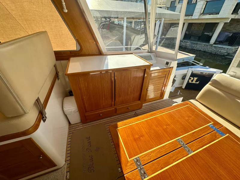 Slide: The Image of Interior of 2001 Grand Banks 49 Eastbay HX with wooden cabinetry and seating. - 35