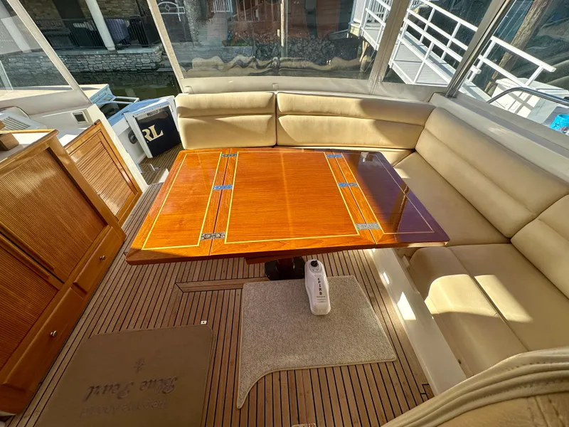 Slide: The Image of 2001 Grand Banks 49 Eastbay HX interior with wooden table and beige seating. - 37