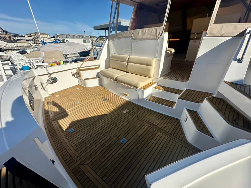 Slide: The Image of 2001 Grand Banks 49 Eastbay HX yacht with teak deck and cushioned seating. - 38