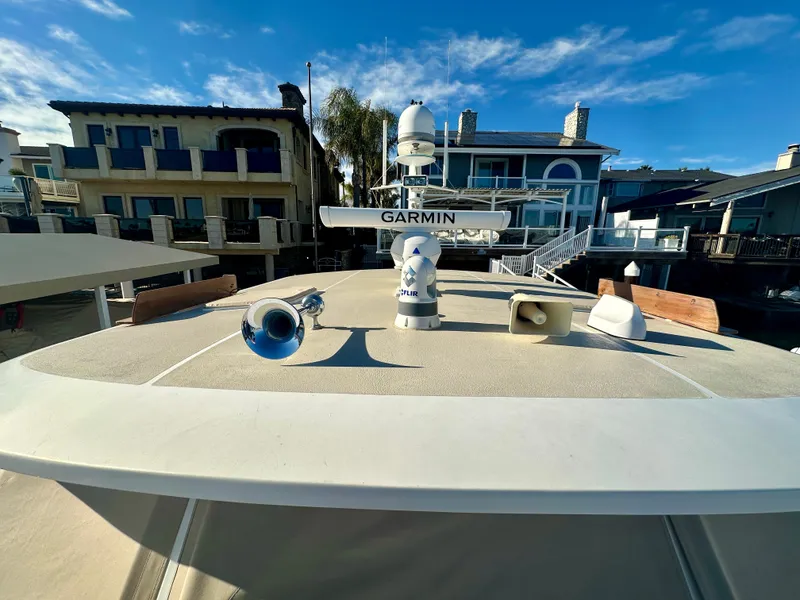 Slide: The Image of 2001 Grand Banks 49 Eastbay HX yacht with Garmin equipment, docked near waterfront homes. - 40