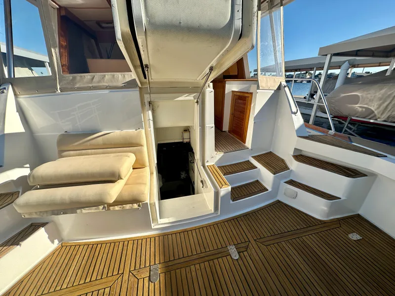 Slide: The Image of 2001 Grand Banks 49 Eastbay HX yacht interior with wooden deck and seating area. - 41