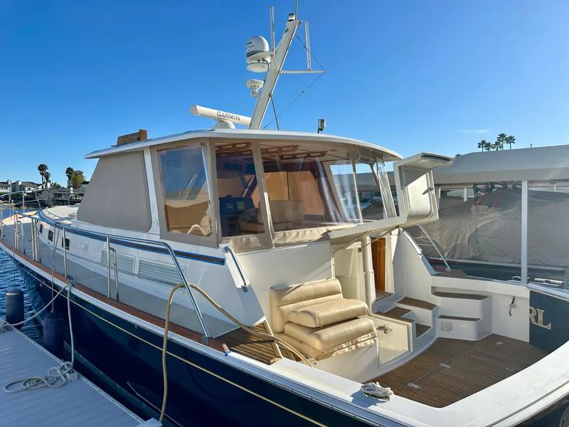 Slide: The Image of 2001 Grand Banks 49 Eastbay HX yacht docked under clear blue sky. - 46
