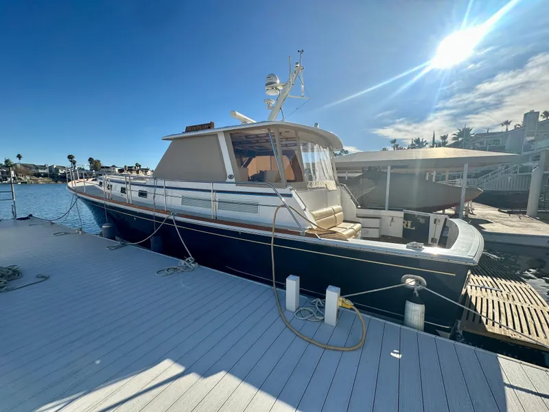 Slide: The Image of 2001 Grand Banks 49 Eastbay HX yacht docked under sunny skies. - 47