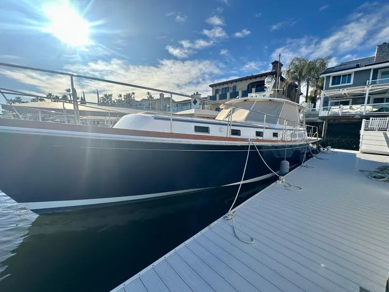 Slide: The Image of 2001 Grand Banks 49 Eastbay HX yacht docked at marina under blue sky. - 48