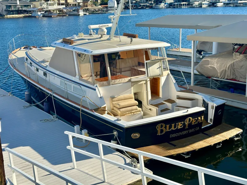Slide: The Image of 2001 Grand Banks 49 Eastbay HX yacht docked in a marina. - 49