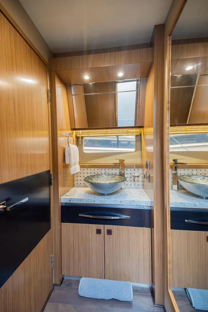 Slide: The Image of Luxurious bathroom in 2017 Sea Ray 59 Flybridge yacht with modern fixtures and wood accents. - 24