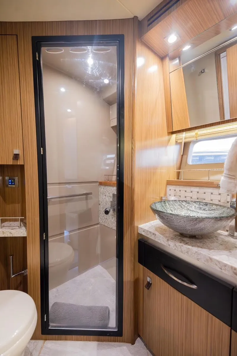 Slide: The Image of Luxurious bathroom in 2017 Sea Ray 59 Flybridge yacht with modern fixtures and elegant design. - 27