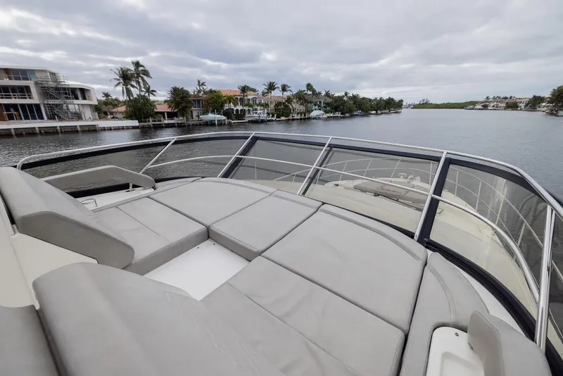 Slide: The Image of 2017 Sea Ray 59 Flybridge yacht with spacious deck overlooking waterfront homes. - 7