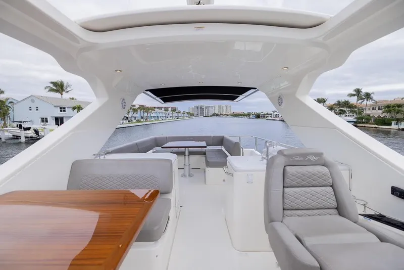 Slide: The Image of 2017 Sea Ray 59 Flybridge yacht interior with luxurious seating and dining area. - 9