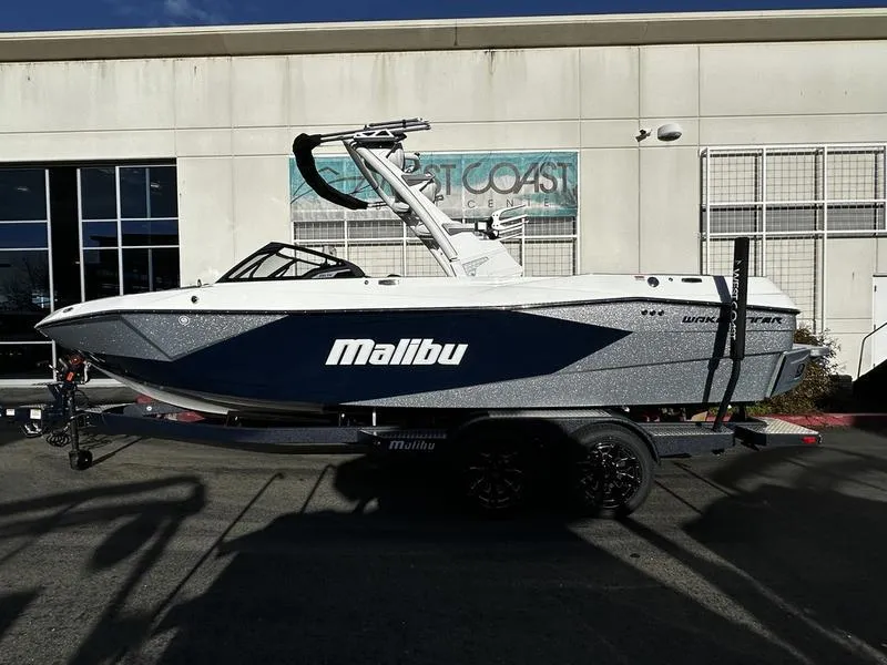 The Image of 2025 Malibu Wakesetter 23 LSV boat on trailer, parked outside a building. - 0