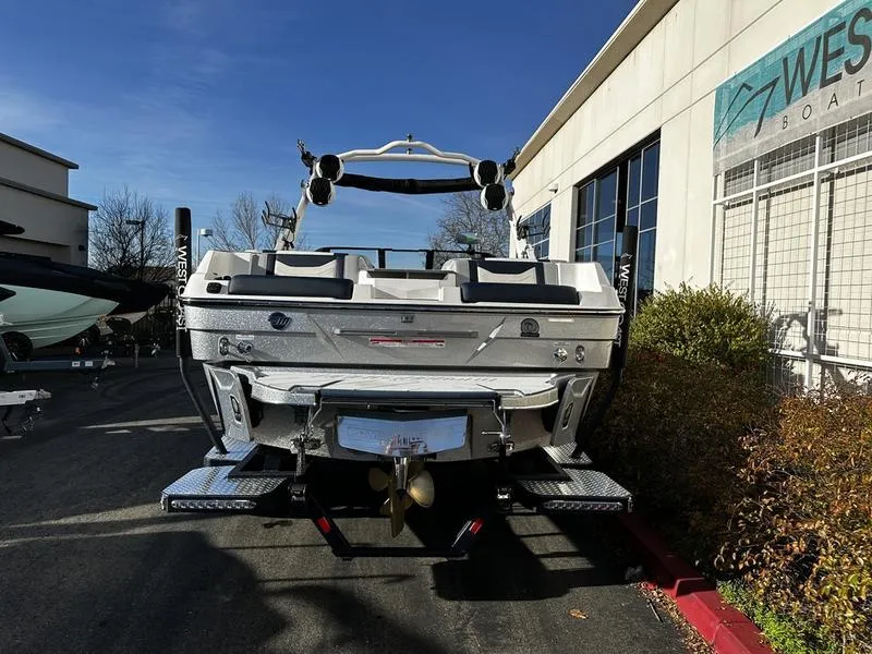 Slide: The Image of 2025 Malibu Wakesetter 23 LSV boat parked outside West Boats dealership. - 2