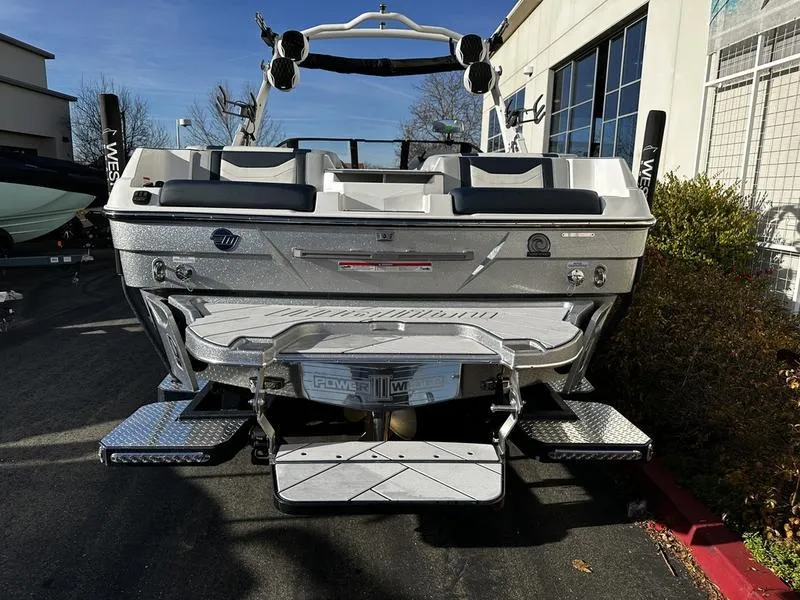 Slide: The Image of 2025 Malibu Wakesetter 23 LSV boat, rear view, parked outdoors. - 4