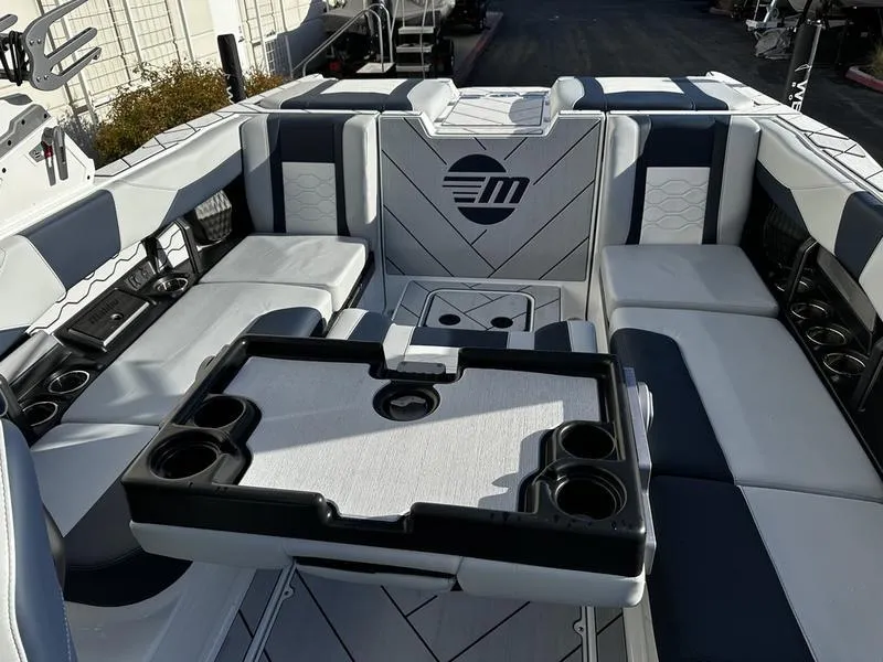 Slide: The Image of 2025 Malibu Wakesetter 23 LSV interior with seating and table, featuring modern design. - 9