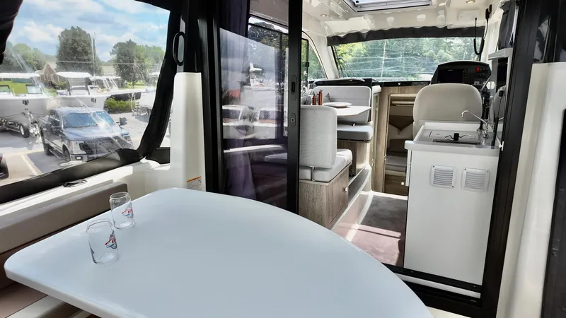 Slide: The Image of Interior of 2025 Bayliner Trophy 29 Explorer, featuring dining area and kitchenette. - 12