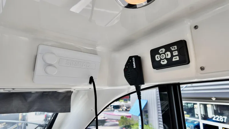 Slide: The Image of Interior controls of 2025 Bayliner Trophy 29 Explorer boat, featuring Simrad equipment. - 13