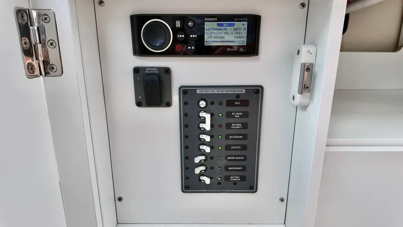 Slide: The Image of Control panel of 2025 Bayliner Trophy 29 Explorer with audio system and circuit switches. - 16
